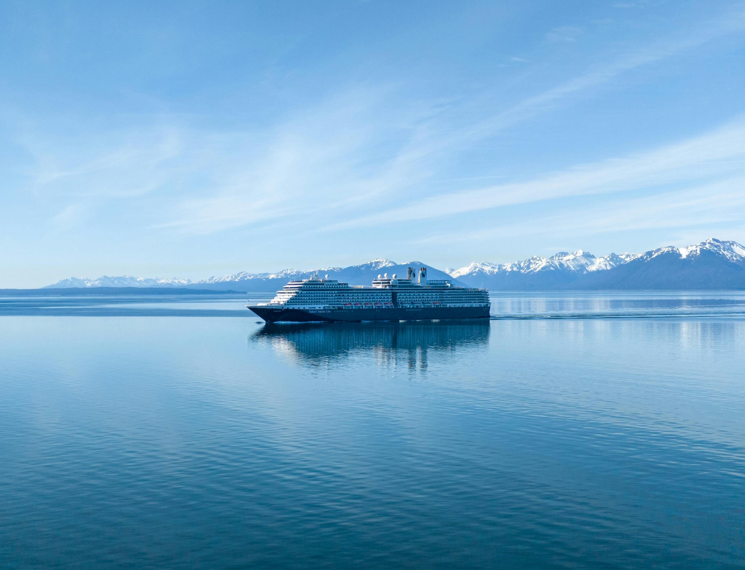 Tour boat navigating near a massive glacier, offering breathtaking views.